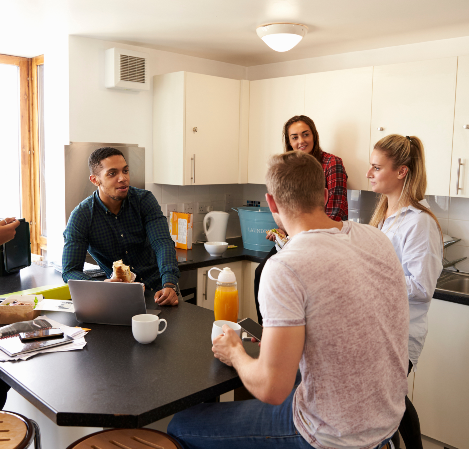 A Group Of Young People In A Kitchen
