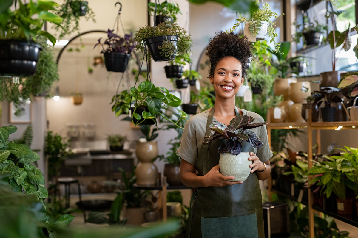 Happy Woman With Plant